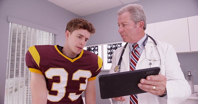 concerned-football-athlete-with-doctor.jpg