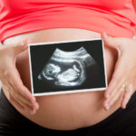 pregnant-woman-holding-ultrasound.jpg